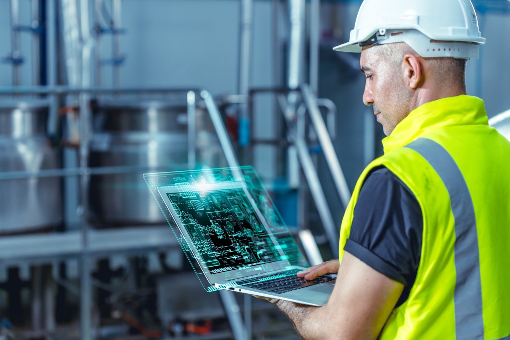 smart,engineer,worker,using,software,on,laptop,to,monitor,check